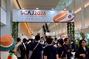 Visitors beneath the SCAJ 2026 entrance banner in Japan