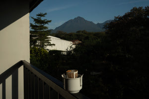 Drip coffee on a balcony overlooking a mountain landscape